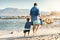 Well find a good spot to build some sandcastles. Rearview shot of a father and his little son bonding together at the