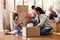 Well find a place for everything soon. Shot of a young family moving house.