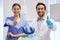 Well get your teeth looking good. Portrait of two young dentists showing thumbs up in their consulting room.