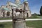 Well, Green grass on background temple. A Spring day