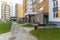 Well-groomed and clean courtyard of a multi-storey building. View of the entrance and the first floor of a residential building.