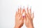 Well-groomed female hands with elegant french manicure on a white background. Long nails. Beauty salon. Photo for the