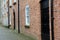 Well-kept brick and stone buildings on cobblestone walkway