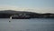 The well known shipping company Hurtigruten leaving the Tromsoe city harbor in autumn sunshine