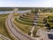 A well-planned city road interchange near the recreational touristic zone at the river background. A view from a height to the wel