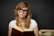 Well-read woman looks through spectacles