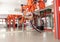 Well stretched woman doing splits with help of orange fabric suspension, aerial yoga