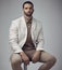 A well-tailored suit provides unlimited confidence. Shot of a handsome young man sitting alone in the studio during the