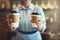 Well take care of your coffee fix. Closeup shot of an unrecognizable barista holding cups of coffee in a cafe.