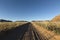 Well used, Dusty desert road to nowhere. Southern Namibia. Mountain scenery surrounding.