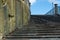 Well worn Sandstone stairs against blue sky.