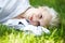 Wellbeing. Happy smiling woman has rest on grass