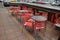 WELLINGTON, NEW ZEALAND - May 28, 2019: View of red plastic outside cafe chairs and metal tables wet after rain