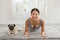 Wellness Asian woman practice yoga Plank pose to meditation with dog pug breed at home Feeling comfortable and relax.Healthy asian