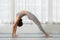 Wellness Attractive Asian indian woman practice yoga bridge pose to meditation and breathing in bedroom after wake up in the