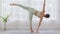 Wellness Attractive Asian indian woman practice yoga Half Moon pose or Ardha Chandrasana to meditation and breathing in bedroom