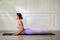 Wellness Attractive Asian woman in purple wear doing yoga Cobra pose at home to meditation comfortable and relax,Calm of healthy