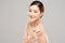 Wellness Beautiful Young Asian Woman Looking While Touching Shoulder feeling so happy and cheerful with healthy Clean and Fresh