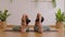 Wellness Couple Asian young woman sit on yoga mat doing breathing exercise yoga sitting forward fold pose stretching together.Yoga