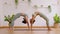 Wellness Couple Asian young woman on yoga mat doing breathing exercise yoga bridge pose stretching muscle warm up together.Yoga