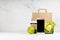 Wellness food - blank phone with set of salad with avocado, cup of coffee, green apple, paper pack in white interior. Mockup.