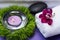Wellness Relax concept with Spa elements. White Towels, Basalt Stones, Orchid, Lavender Tea Light Candle and Dianthus Flowers