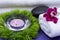 Wellness Relax concept with Spa elements. White Towels, Basalt Stones, Orchid, Lavender Tea Light Candle and Dianthus Flowers