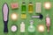 Wellness and spa products, laser feet grater, cream, lotion, soap, pink salt and candle on green towel