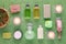 Wellness and spa products, shampoo, cream, lotion, soap, pink salt and plants with candles on green towel