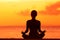 Wellness woman doing zen yoga meditation on beach