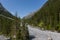 Welschtobel valley near Arosa in sunlight, forest, debris, blue