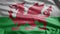 Welsh flag waving in the wind. Close up of Wales banner blowing soft silk