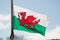 Welsh National Flag Flying in the Wind against Blue Sky