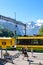 Wengen, Switzerland - July 16 2019: Family on trip walking on platform in main train statio. Beautiful Alps with snow on top in