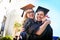 Were feeling all the feels right now. a young couple embracing each other on graduation day.