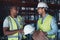 Were friends more than coworkers. two young contractors standing in the warehouse together and having a discussion.