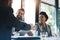 Were going to work so well together. businesspeople shaking hands during a meeting in an office.