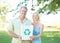 Were passionate about conservation. A happy couple standing in a park holding a recycling bin and smiling at the camera.
