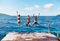 Were young and living our best lives this summer. Rearview shot of a group of young women jumping off a pier and into