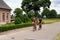 Wernhout, North Brabant, The Netherlands, Middle aged couple driving the bicycle at the Dutch Belgian border