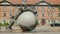 Wernigerode, Germany, May 2018: The original fountain in the form of a ball, it has a tree trunk and sculptures. Small