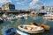 West bay harbour Dorset with boats on a calm summer day blue sky and sea