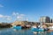 West bay harbour Dorset on a calm summer day with boats blue sky and sea