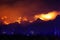 West coast wildfire tears through mountain range