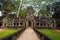 West gate of Ta Prohm, Angkor, Cambodia. Jungle temple with massive trees growing out of its walls