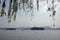 West Lake Xi Hu in Hangzhou, Zhejiang Province, China. View beneath a willow tree towards Leifeng Pagoda