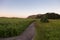 West view of deserted path along the Baie-St-Paul beach seen during a summer sunrise