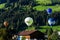 Westendorf, Tirol/Austria - September 27 2018: Four different hot-air balloons flying low over the houses and hills of Westendorf