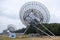 Westerbork Synthesis Radio Telescope surrounded by forests under a cloudy sky in the Netherlands