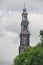 Westerkerk clock tower and canal view in Amsterdam. It is next to Amsterdam\'s Jordaan distr